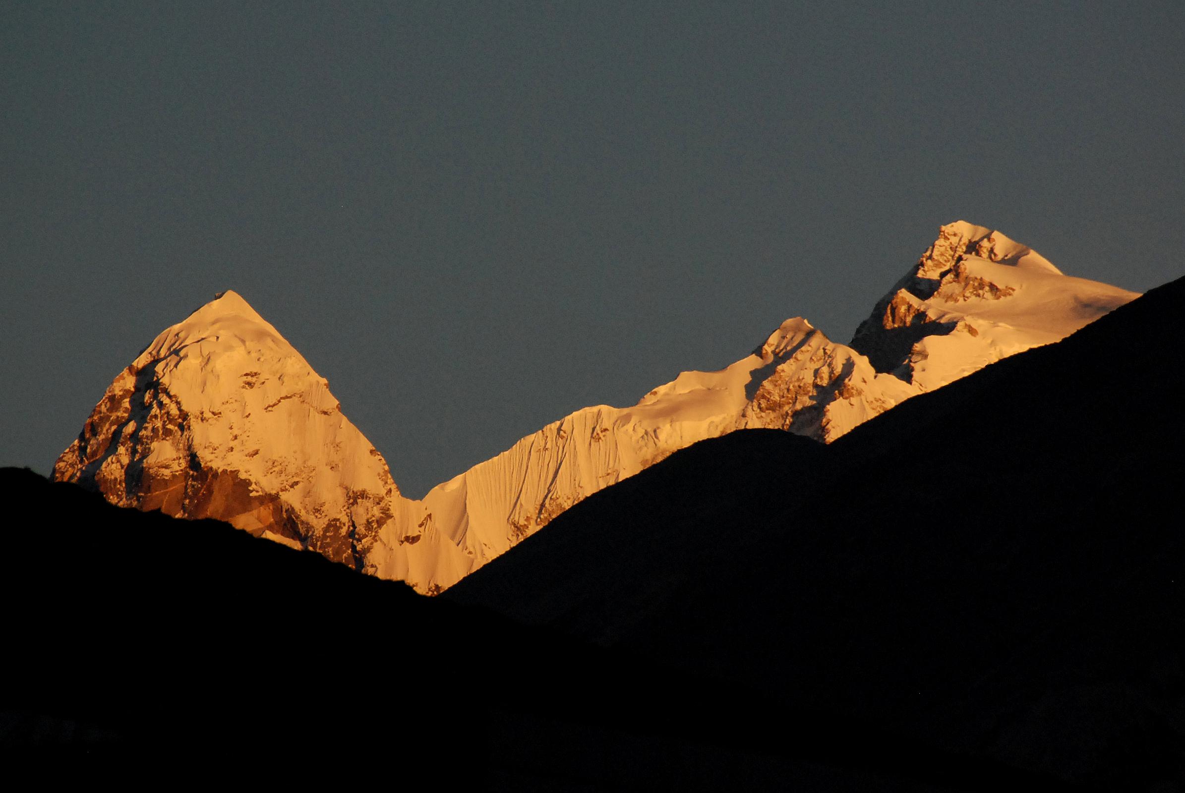 01 Nyanang Ri, Pungpa Ri and Shishapangma At Sunrise From Nyalam Nyanang Ri (7071m), Pungpa Ri (7445m) and Shishapangma (8012m) shine at sunrise from the Shisha Bangma Hotel in Nyalam.